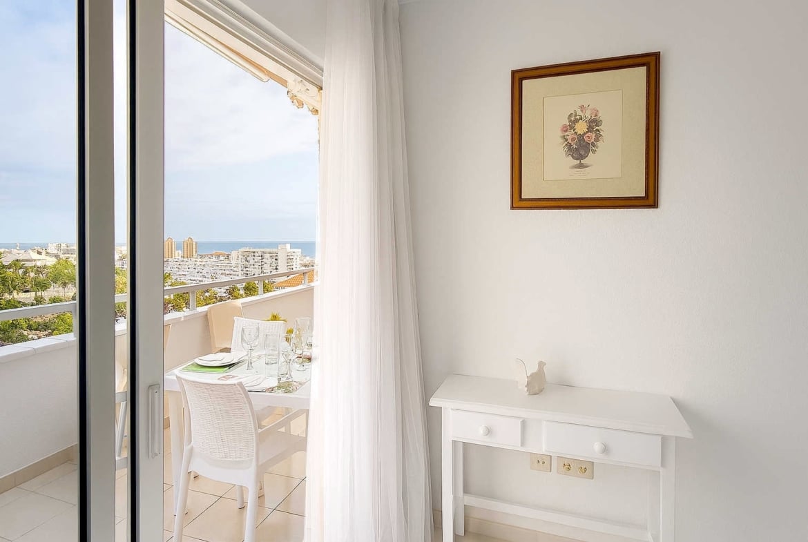 Amplio apartamento en venta en San Eugenio Alto, Tenerife, con terraza de 16 m², vistas al mar, piscina comunitaria climatizada y cerca de Playa de las Américas.