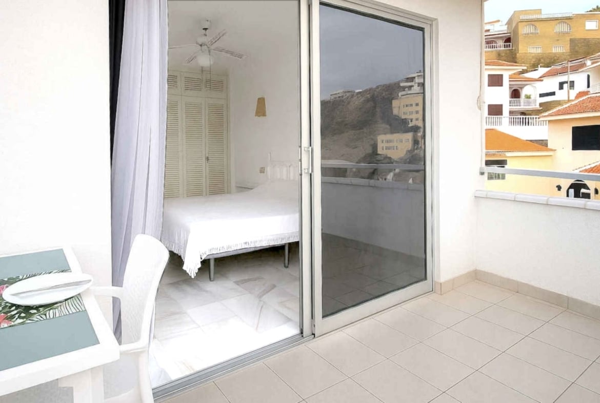 Amplio apartamento en venta en San Eugenio Alto, Tenerife, con terraza de 16 m², vistas al mar, piscina comunitaria climatizada y cerca de Playa de las Américas.